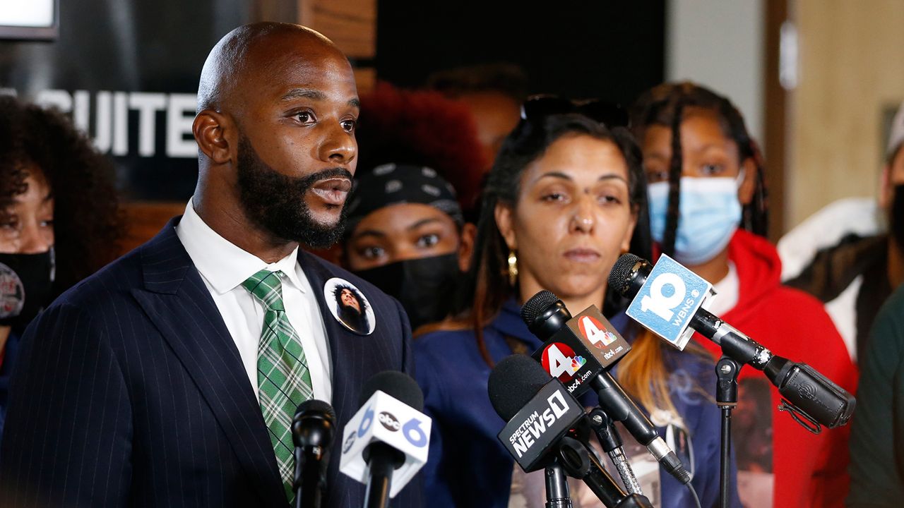 Sean Walton, left, attorney representing Tamala Payne, right, the mother of Casey Goodson Jr., speaks during a news conference Thursday, Dec. 2, 2021, in Columbus, Ohio about the indictment of a former deputy who shot and killed her son. Jason Mead, the Ohio sheriff's deputy who fatally shot Casey Goodson Jr. in the back five times has been charged with murder and reckless homicide.(AP Photo/Jay LaPrete)