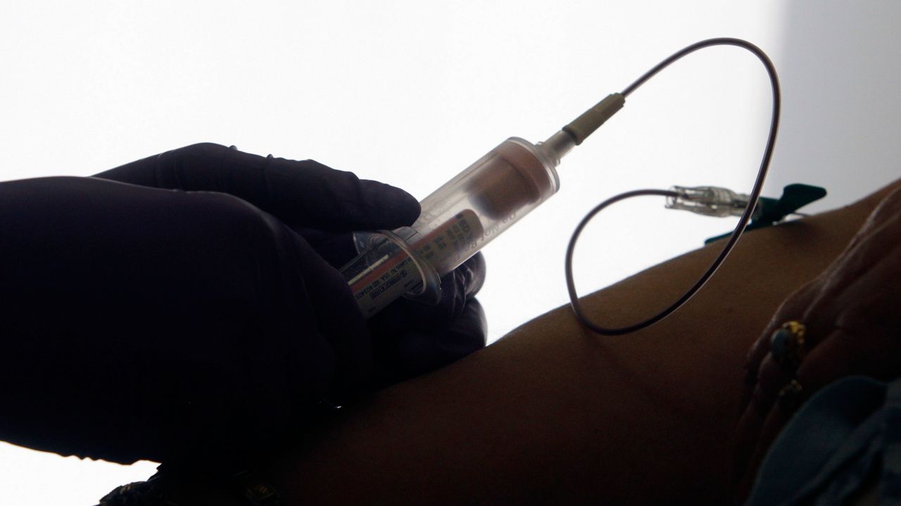 In this April 28, 2015 file photo, a patient has her blood drawn for a liquid biopsy during an appointment at a hospital in Philadelphia.