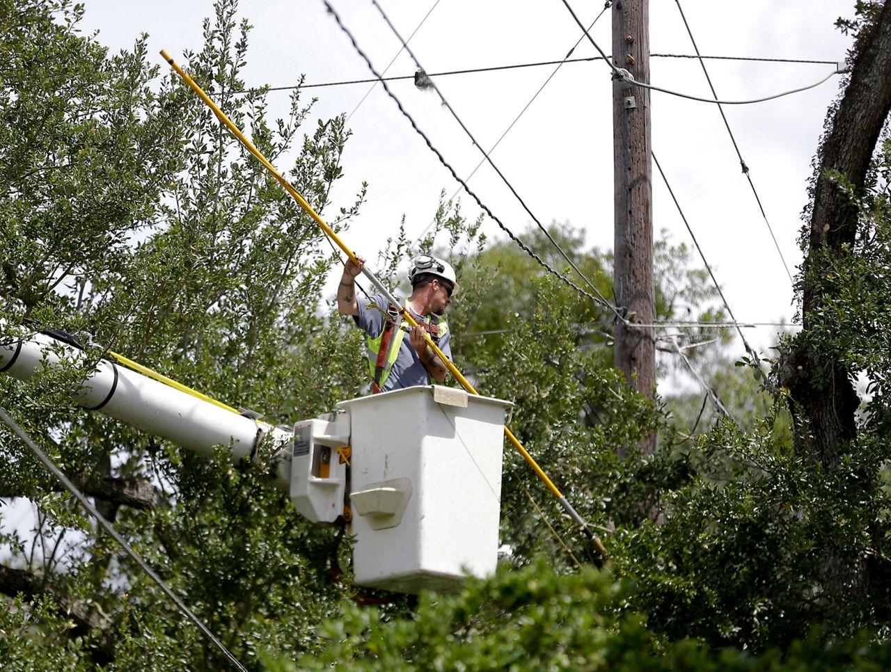 A power company employee worked to restore power following Hurricane Irma.  Photo by the Associated Press.