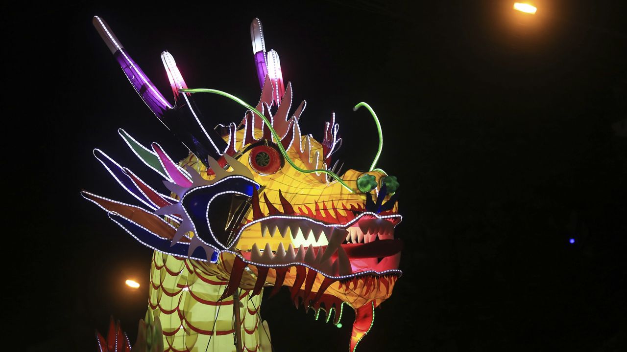 A dragon lantern parades through the streets to celebrate the Mid-Autumn, or Moon festival in Tuyen Quang city, Vietnam, Monday, Oct. 2, 2017. (AP Photo/Hau Dinh)