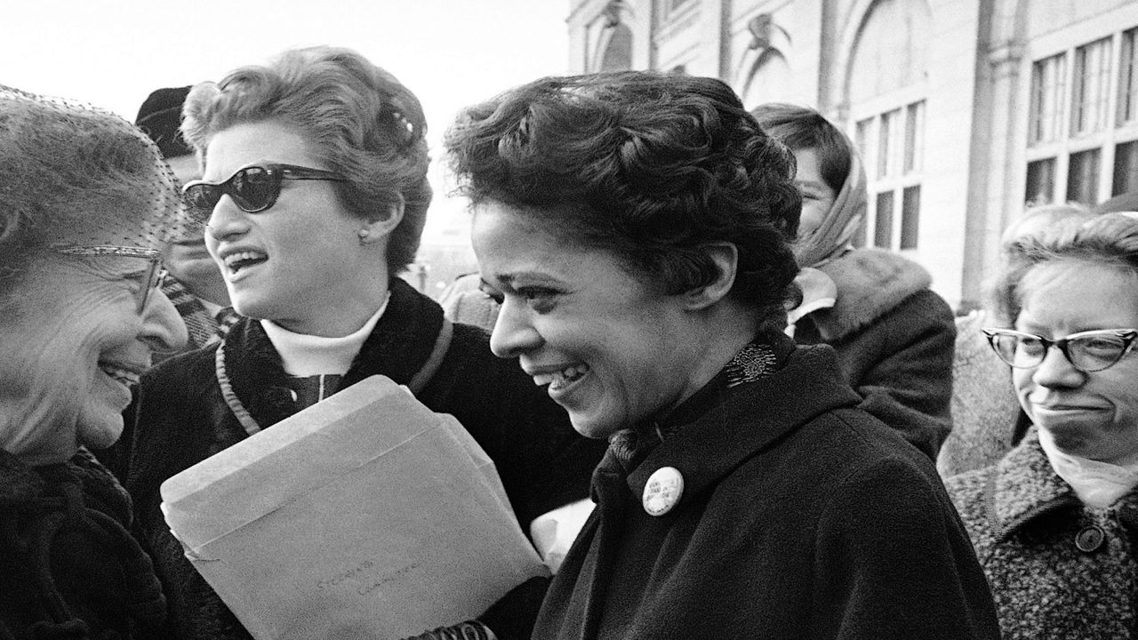 FILE - In this Jan. 16, 1968, file photo, Milwaukee alderman Vel Phillips, right, is greeted on her arrival to participate in a protest march in Washington by Jeanette Rankin, former Montana congresswoman and leader of the protest march. Phillips, a civil rights pioneer who helped lead open housing marches in Milwaukee in the 1960s and was the first black person elected to statewide office in Wisconsin, died Tuesday, April 17, 2018, in hospice care. She was 94. (AP Photo/Henry Burroughs, File)