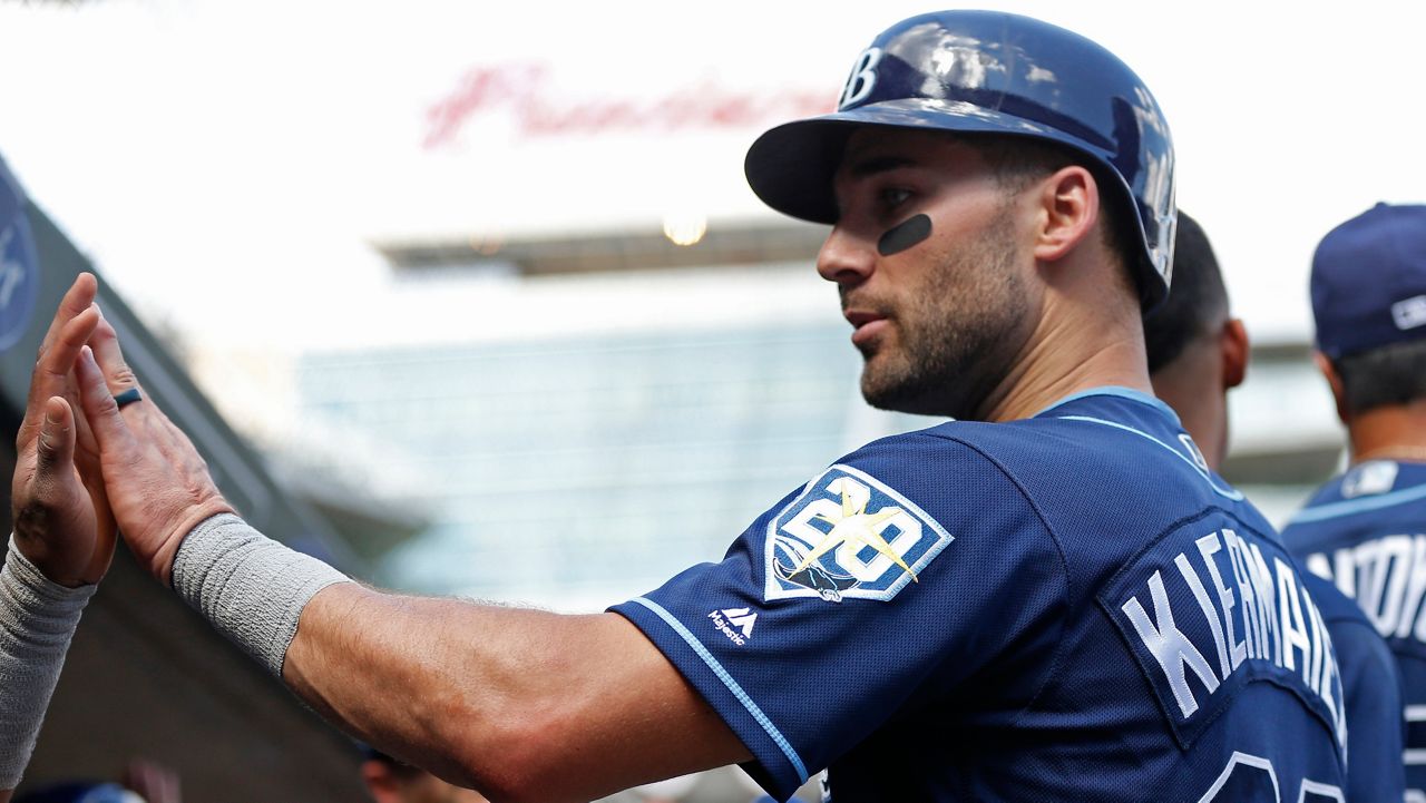 FILE - Tampa Bay Rays' Kevin Kiermaier is congratulated after scoring against the Minnesota Twins in a baseball game Saturday, July 14, 2018, in Minneapolis. (AP Photo/Jim Mone)