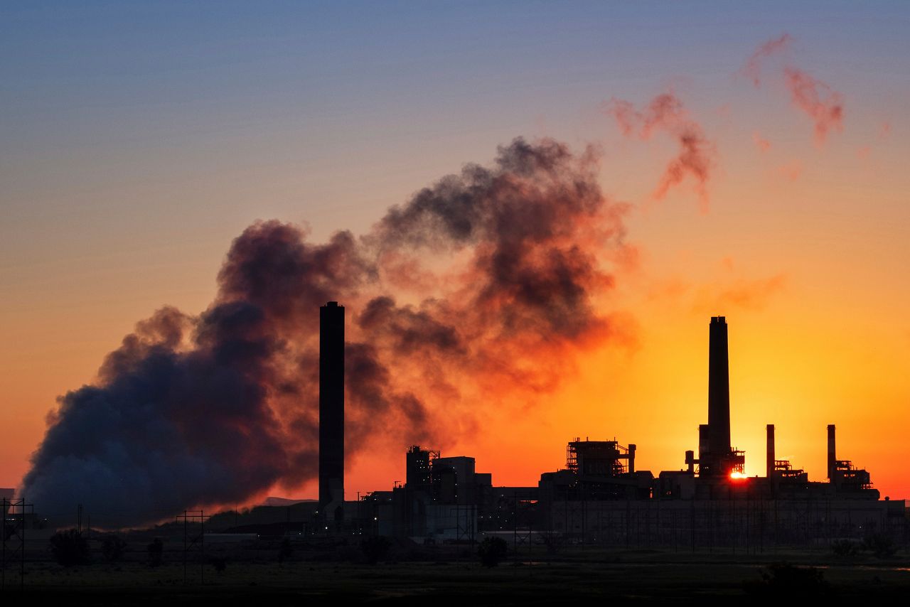FILE - In this July 27, 2018, file photo, the Dave Johnson coal-fired power plant is silhouetted against the morning sun in Glenrock, Wyo. (AP Photo/J. David Ake, File)