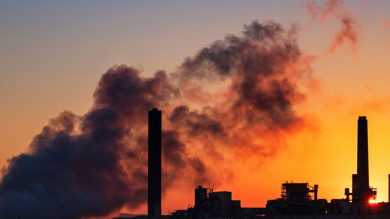 In this July 27, 2018, file photo, the Dave Johnson coal-fired power plant is silhouetted against the morning sun in Glenrock, Wyo. As the Trump administration rolls back environmental and safety rules for the U.S. energy sector, government projections show billions of dollars in savings reaped by companies will come at a steep cost: increased premature deaths and illnesses from air pollution, a jump in climate-warming emissions and more derailments of trains carrying explosive fuels. (AP Photo/J. David Ake)