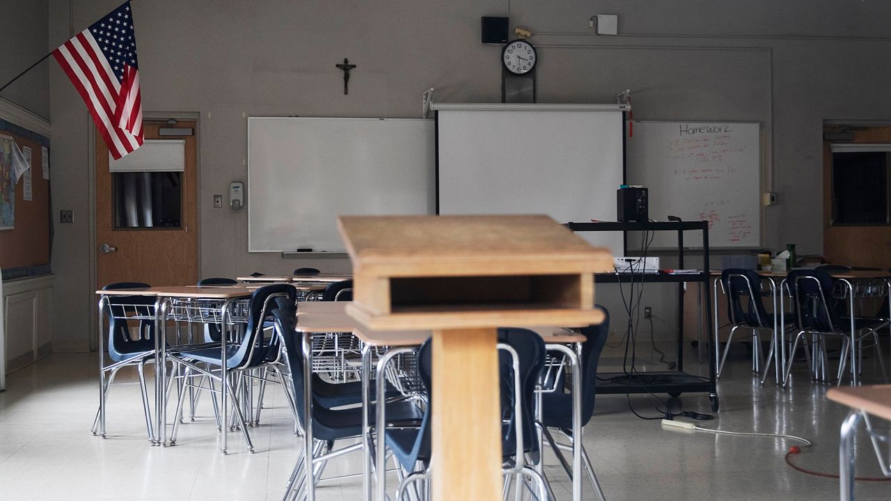 A large, empty classroom, lit by morning light. (iStock)