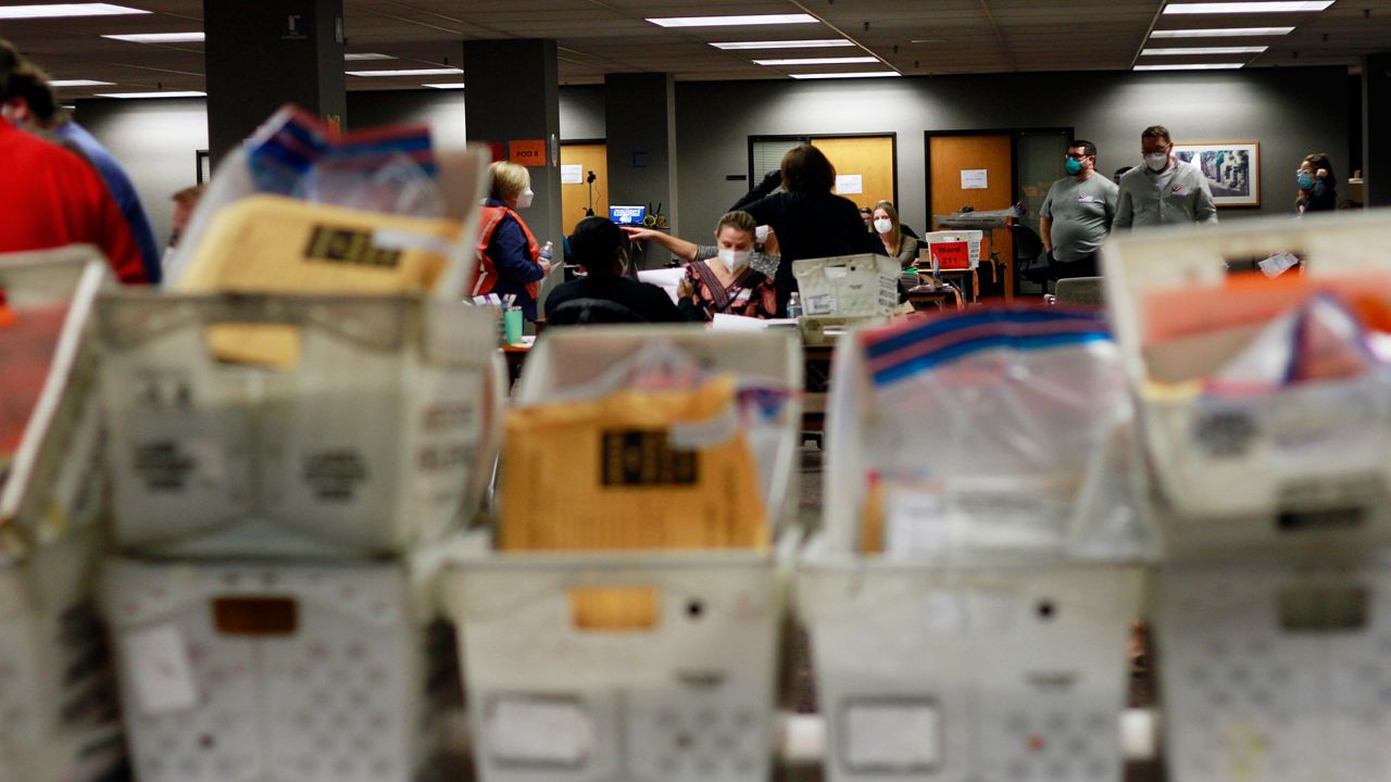 Election workers count absentee ballots