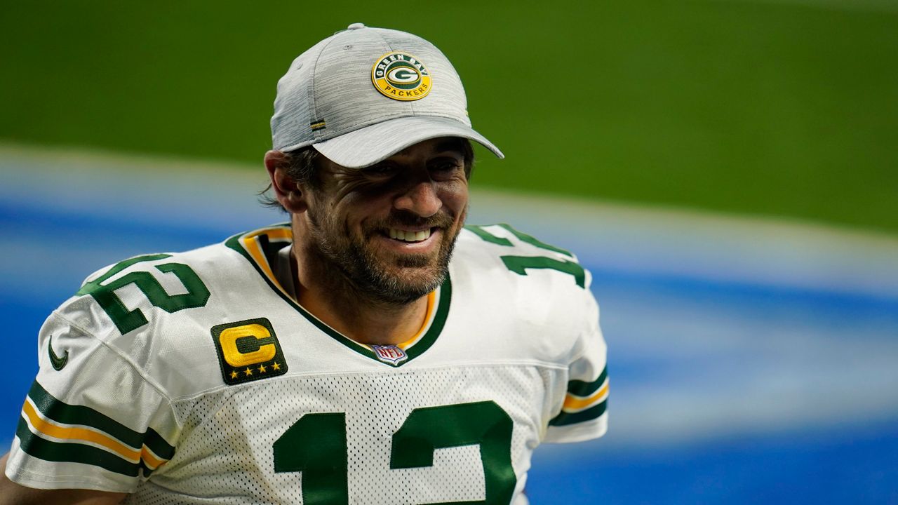 Quarterback Aaron Rodgers walks off the field after an NFL football game against the Detroit Lions. (AP Photo/Paul Sancya)