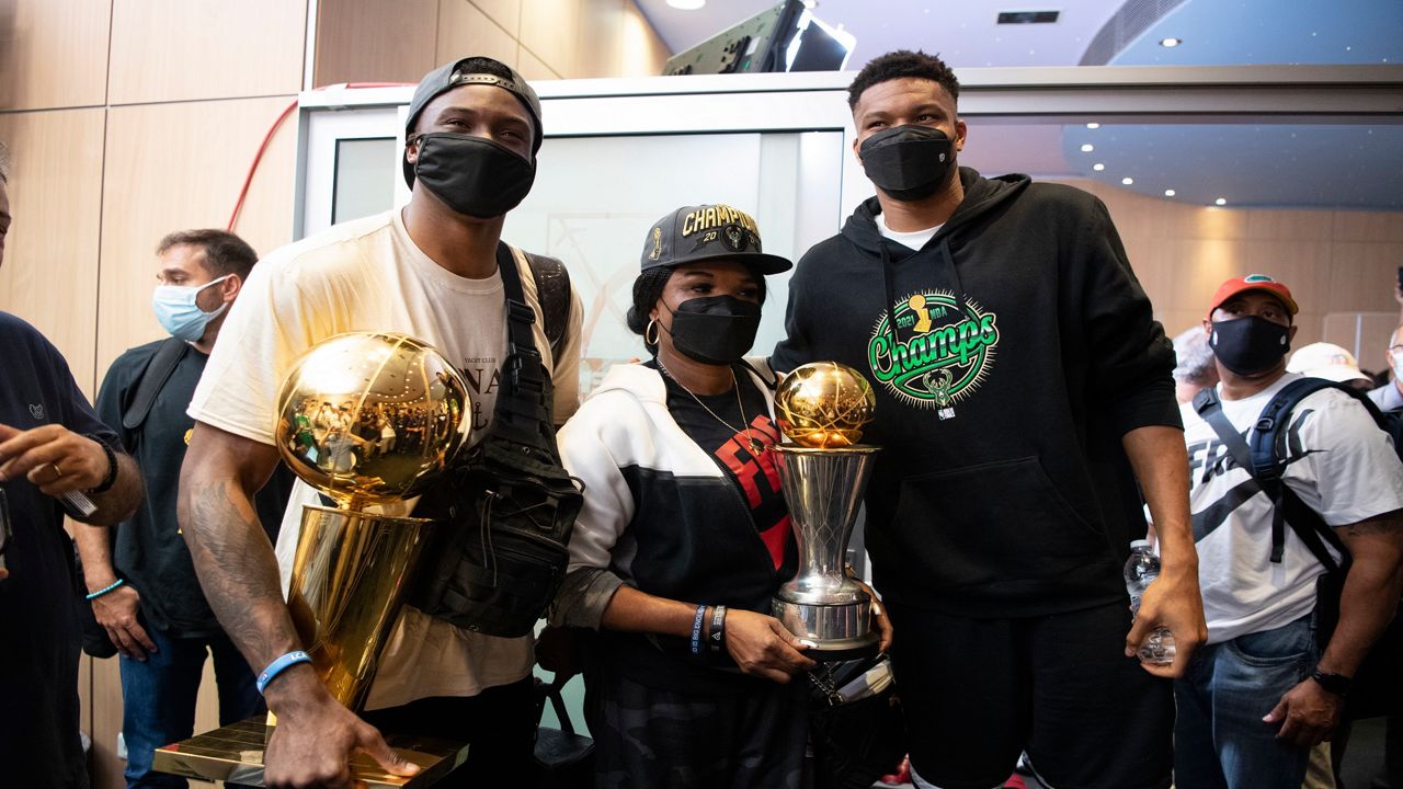 Giannis Antetokounmpo, his mother Veronica and brother Thanasis pose for a picture at the Eleftherios Venizelos International Airport, in Athens. The NBA champion plans to stay in Greece for a few days, before returning to the U.S., where his girlfriend expects their second child later this month. (AP Photo/Michael Varaklas)