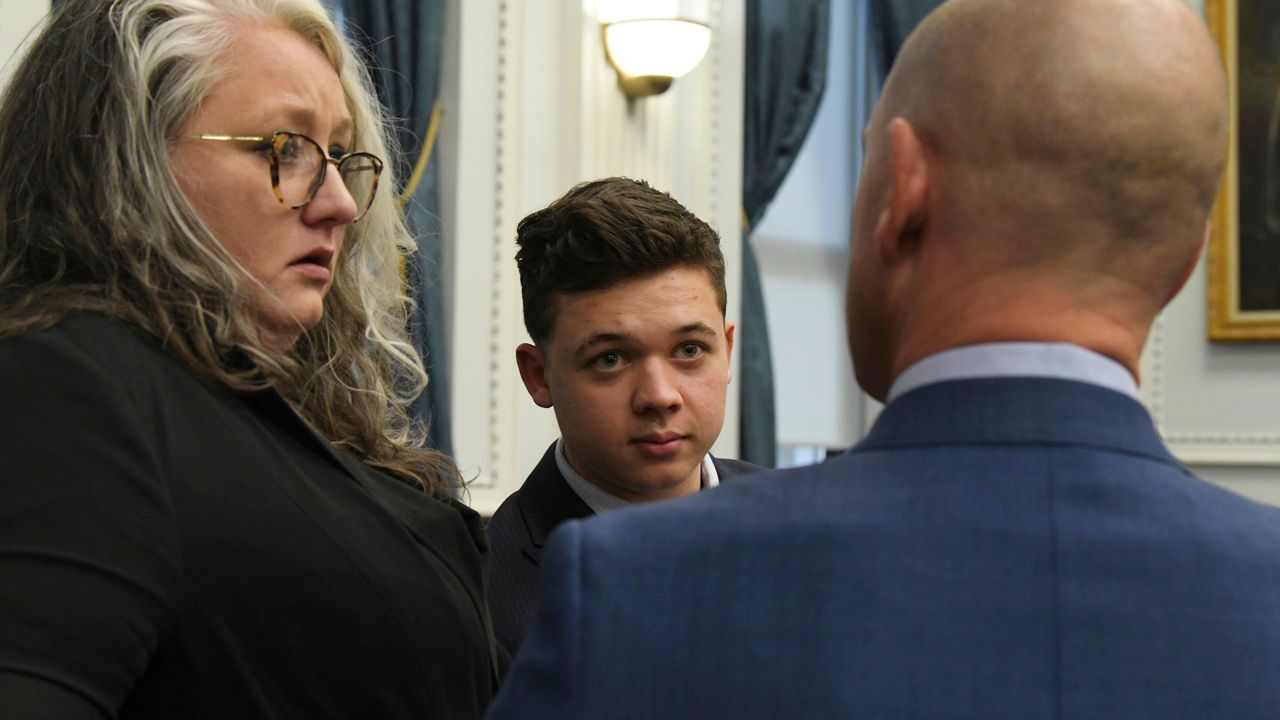 Kyle Rittenhouse and defense attorneys Natalie Wisco and Corey Chirafisi talk at the conclusion of their day in court during the Kyle Rittenhouse trial at the Kenosha County Courthouse in Kenosha, Wis., on Friday, Nov. 5, 2021. Rittenhouse is accused of killing two people and wounding a third during a protest over police brutality in Kenosha, last year. (Mark Hertzberg/Pool Photo via AP)