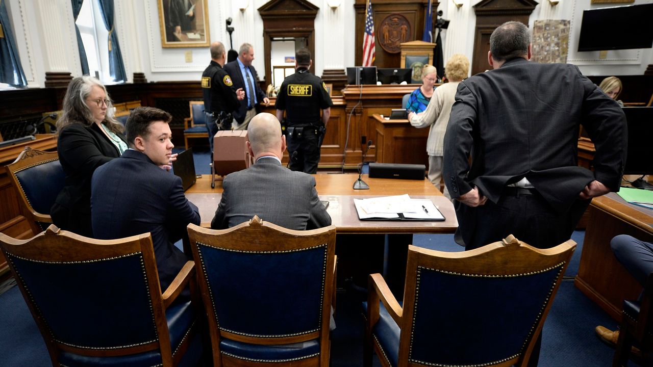 Kyle Rittenhouse, second from left, waits with his legal team for the day to start at his trial at the Kenosha County Courthouse in Kenosha, Wis., on Tuesday, Nov. 16, 2021. Rittenhouse is accused of killing two people and wounding a third during a protest over police brutality in Kenosha, last year. (Sean Krajacic/The Kenosha News via AP, Pool)