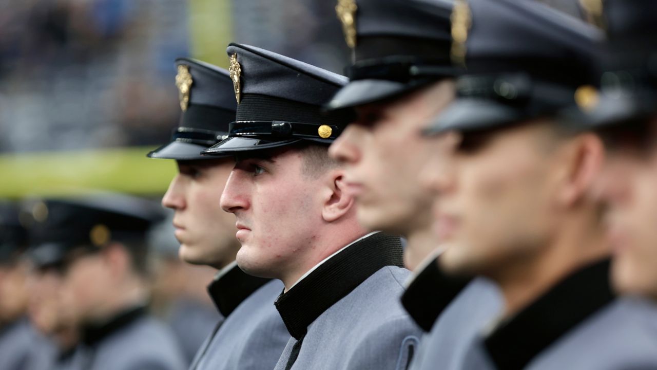 Army cadets march on the field before an NCAA college football game against Navy on Saturday, Dec. 11, 2021, in East Rutherford, N.J. (AP Photo/Adam Hunger)