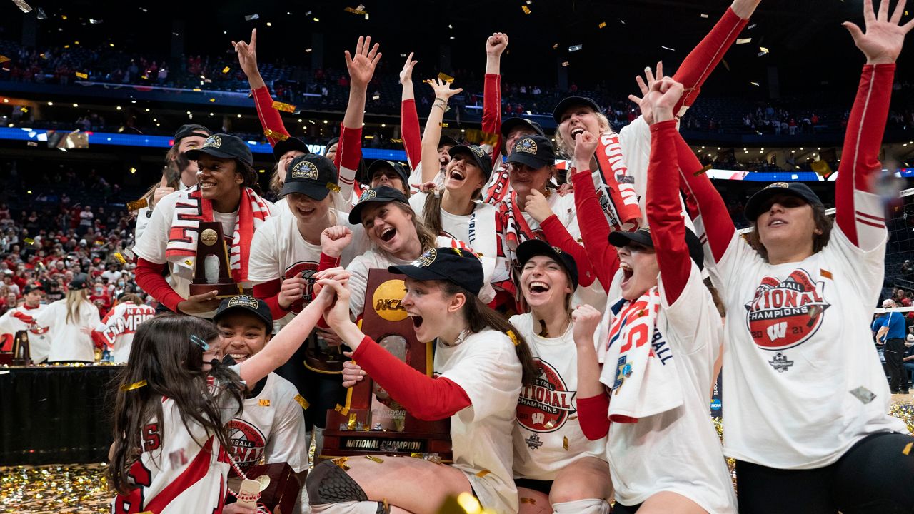 Wisconsin players pose for a photo after defeating Nebraska in the championship match of the NCAA women's college volleyball tournament Saturday, Dec. 18, 2021, in Columbus, Ohio. (AP Photo/Jeff Dean)