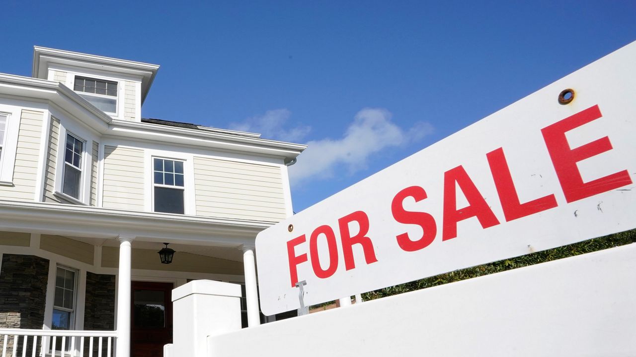 A for sale sign stands in front of a house, Tuesday, Oct. 6, 2020, in Westwood, Mass. (AP Photo/Steven Senne, File)