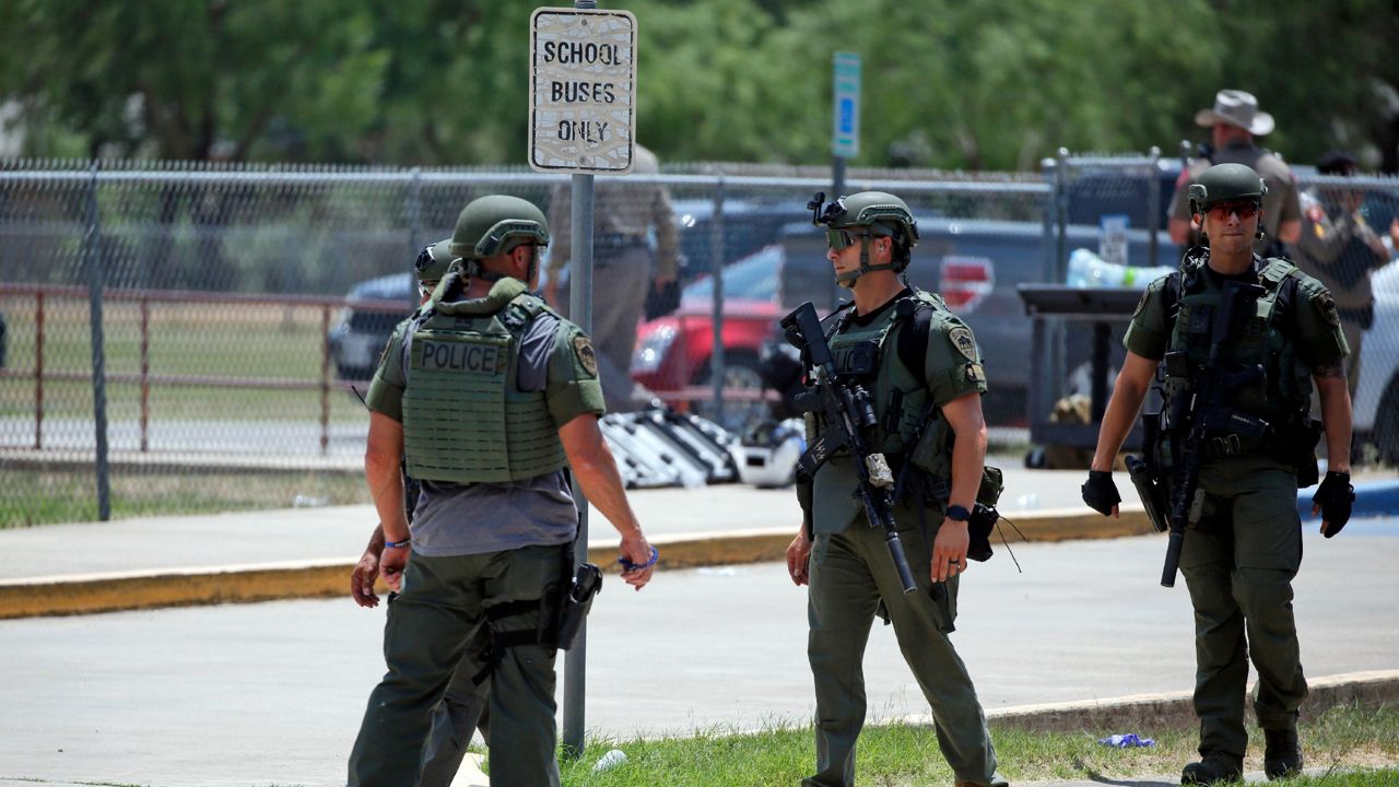 Law enforcement personnel stand outside Robb Elementary School following a shooting, Tuesday, May 24, 2022, in Uvalde, Texas. (AP Photo/Dario Lopez-Mills)