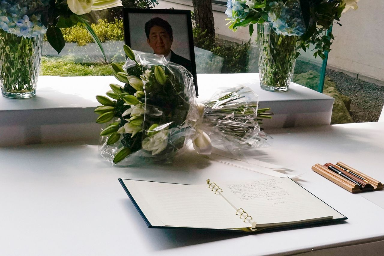 A condolence book open to the page President Joe Biden signed for former Japanese Prime Minister Shinzo Abe, who was assassinated on Friday while campaigning, rests on a table at the Japanese ambassador's residence in Washington, Friday, July 8, 2022. (AP Photo/Susan Walsh)