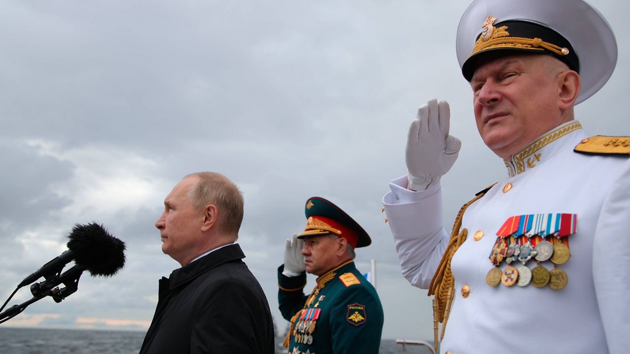 Russian President Vladimir Putin, left, Russian Defense Minister Sergei Shoigu, center, and Commander-in-Chief of the Russian Navy Admiral Nikolai Yevmenov review warships before the main naval parade marking Russian Navy Day in the Gulf of Finland, in St. Petersburg, Russia, Sunday, July 31, 2022. (Mikhail Klimentyev, Sputnik, Kremlin Pool Photo via AP)