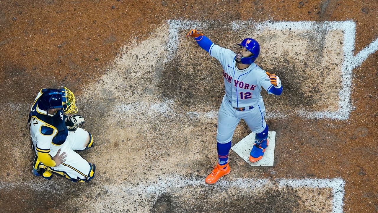 New York Mets' Francisco Lindor reacts in front of Milwaukee Brewers catcher Omar Narvaez after hiiting a grand slam during the seventh inning of a baseball game Tuesday, Sept. 20, 2022, in Milwaukee. (AP Photo/Morry Gash)