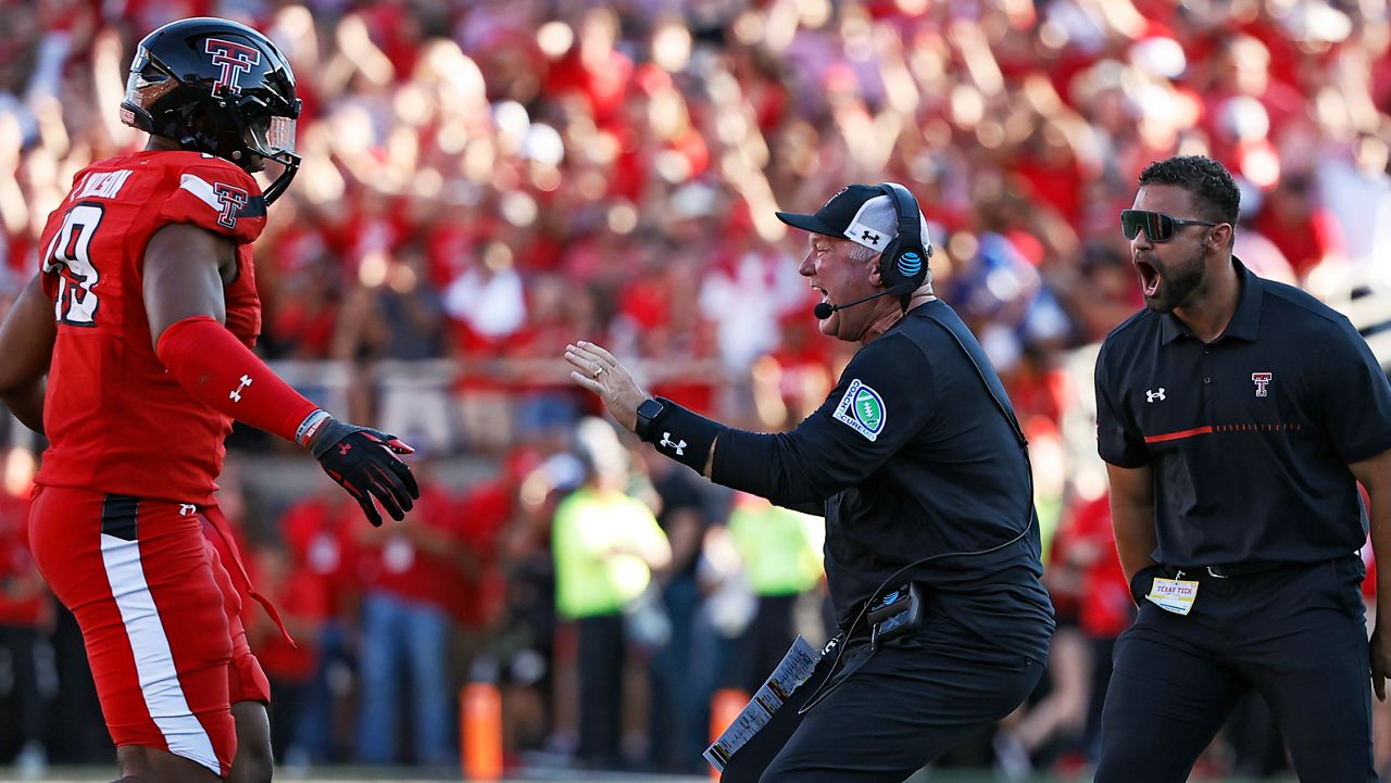 Texas Tech defensive coordinator Tim DeRuyter celebrates with Tyree Wilson (19) during the overtime of an NCAA college football game against Texas, Saturday, Sept. 24, 2022, in Lubbock, Texas. (AP Photo/Brad Tollefson)