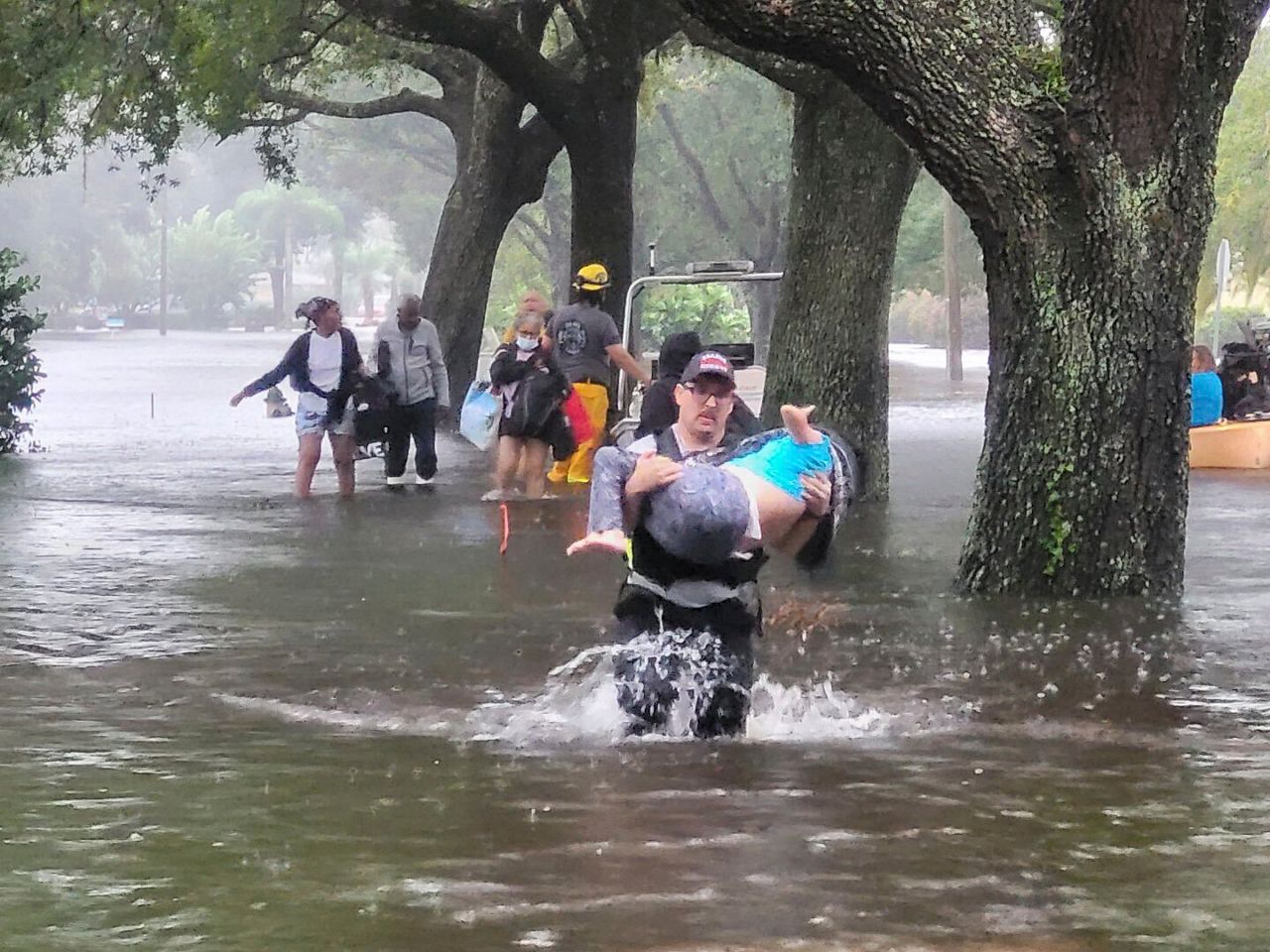 Fire and EMS services provide high water rescues as flood waters rise. (AP)