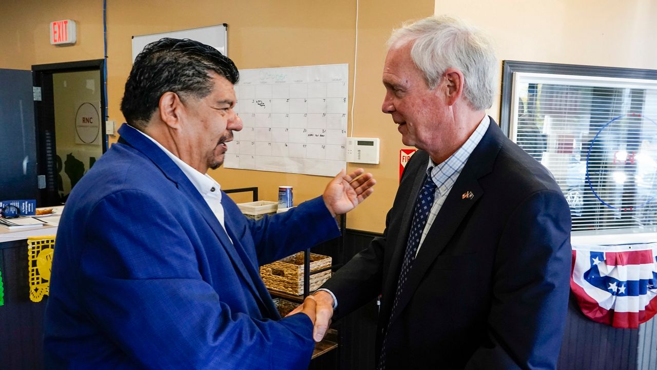 Wisconsin Republican U.S. Senate candidate Ron Johnson and Pastor Marty Calderon shake hands at a local Republican election office in Milwaukee, on Saturday, Oct. 8, 2022. In two decades of street outreach on Milwaukee’s south side, Calderon has offered Bible study, gang prevention, a safe place to stay for those battling addiction, and help getting jobs for those newly released from prison. But as he’s watched rising crime threaten those efforts to “clean up” his impoverished neighborhood, Calderon started bringing Republican politicians to his ministry, God Touch. (AP Photo/Morry Gash)