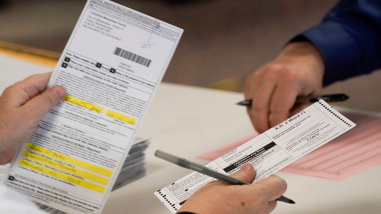 Workers count ballots on Election Day. (AP Photo/Morry Gash)