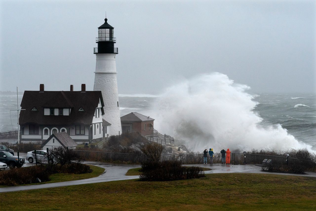 A wave slams into the rocks at Portland Head Light, Maine, during a powerful winter storm, Friday, Dec. 23, in Cape Elizabeth. (AP Photo/Robert F. Bukaty)