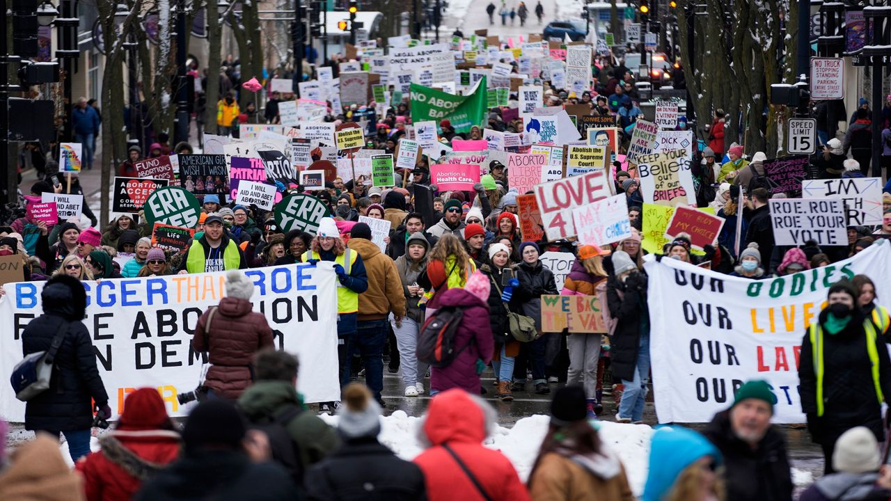 Protesters make their way to the Wisconsin Capitol Rotunda during a march supporting overturning Wisconsin's near total ban on abortion Sunday, Jan. 22, 2023, in Madison, Wis. 