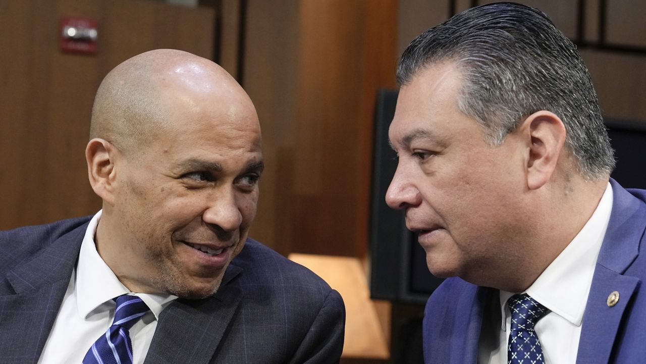 Sen. Cory Booker, D-N.J., left, talks with Sen. Alex Padilla, D-Calif., during a Senate Judiciary Committee business meeting on Feb. 16. (AP Photo/Mariam Zuhaib)