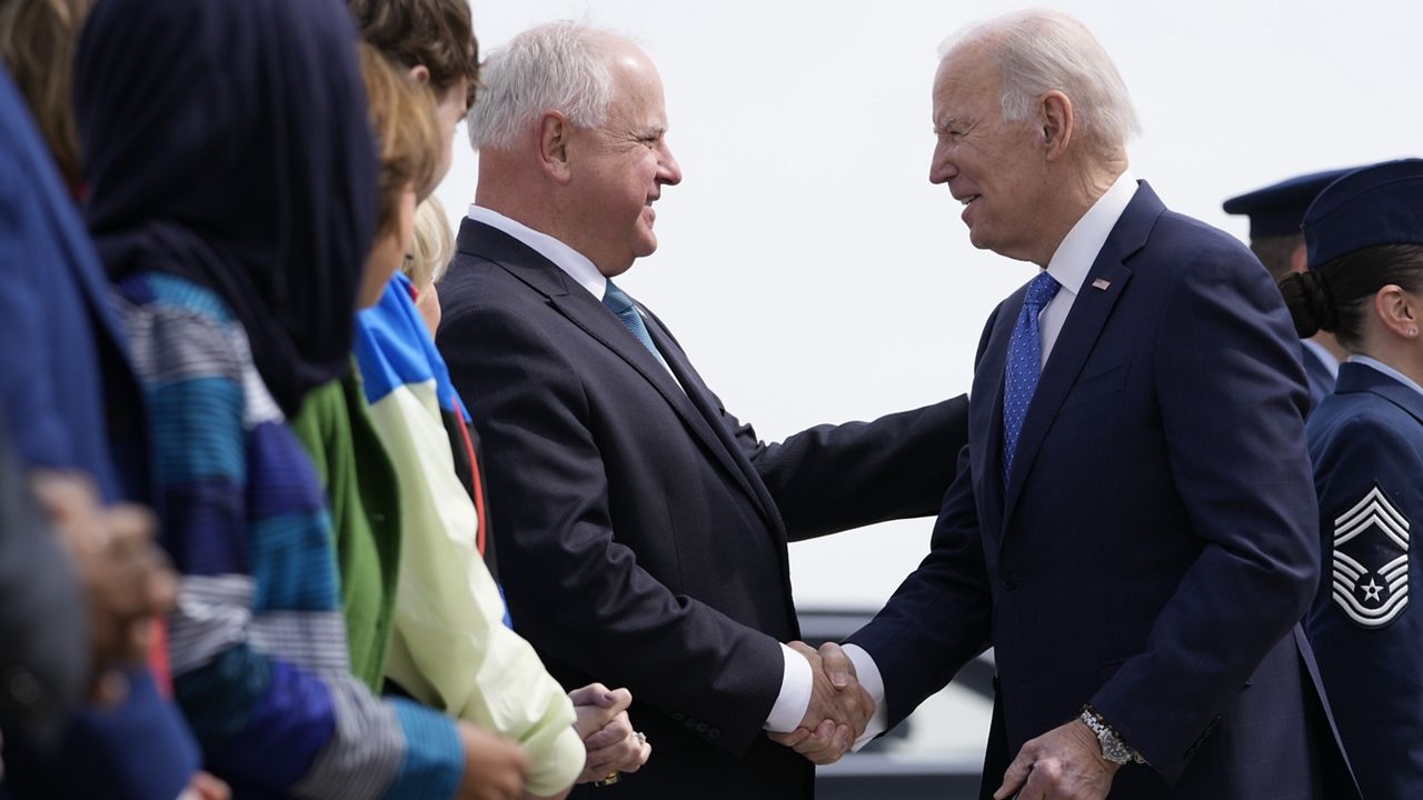 FILE - President Joe Biden shakes hands with Minnesota Gov. Tim Walz as he arrives at Minneapolis−Saint Paul International Airport, Monday, April 3, 2023, in Minneapolis. (AP Photo/Carolyn Kaster)