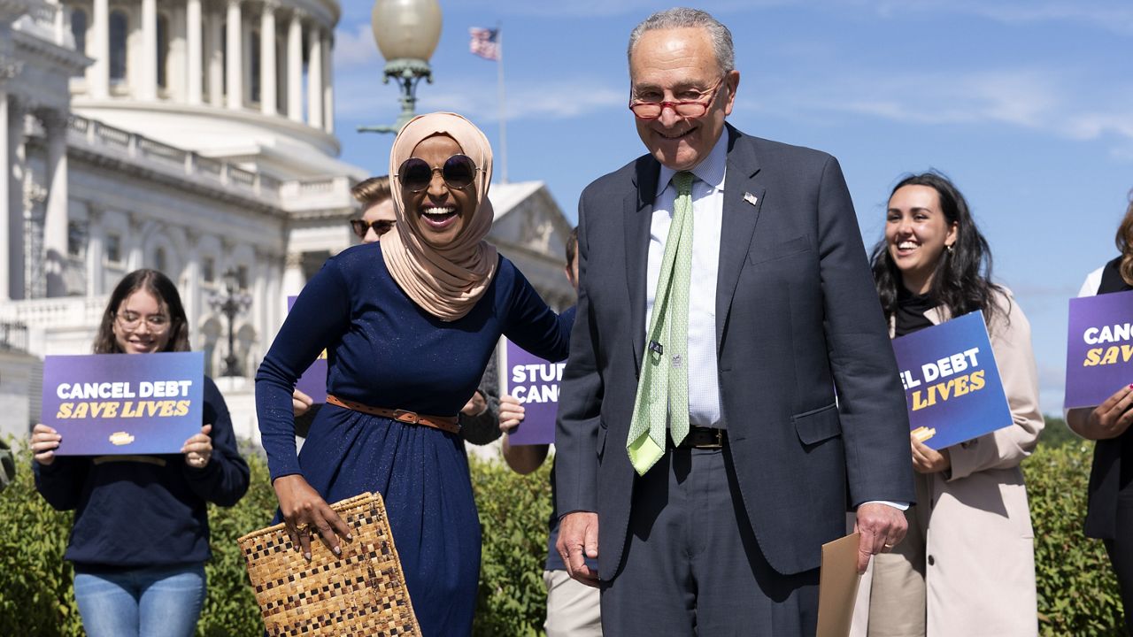 Senate Majority Leader Chuck Schumer, D-N.Y., and Rep. Ilhan Omar, D-Minn., react during a news conference on student debt cancellation on Capitol Hill in Washington, Sept. 29, 2022. ( AP Photo/Jose Luis Magana, File)