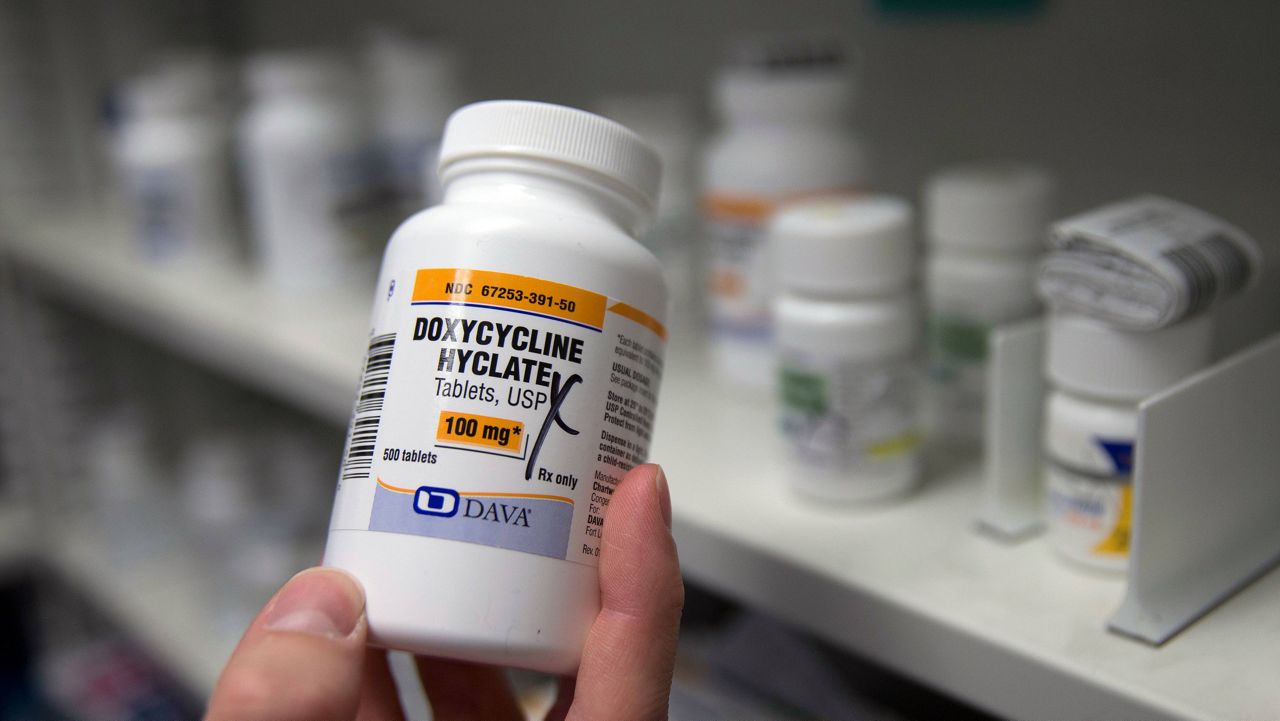 A pharmacist holds a bottle of the antibiotic doxycycline hyclate in Sacramento, Calif., July 8, 2016. On Tuesday, April 11, 2023, the Centers for Disease Control and Prevention released data about some of the most common infectious diseases in the U.S. The numbers show how chlamydia, gonorrhea and syphilis infections have been accelerating across the country. Meanwhile, the CDC is considering recommending the antibiotic doxycycline to be used after sex to prevent those infections. (AP Photo/Rich Pedroncelli,