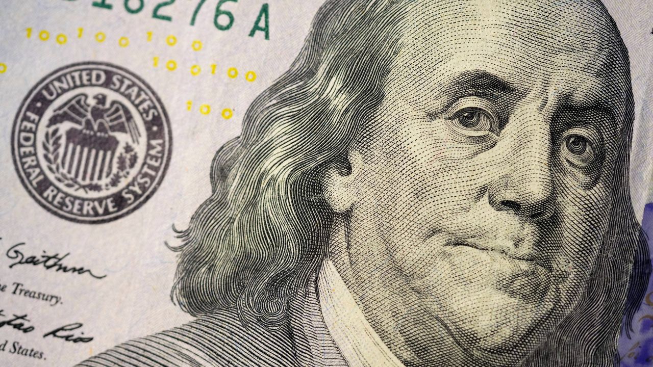The likeness of Benjamin Franklin is seen on a U.S. $100 bill, Wednesday, Feb. 22, 2023, in Marple Township, Pa. (AP Photo/Matt Slocum)