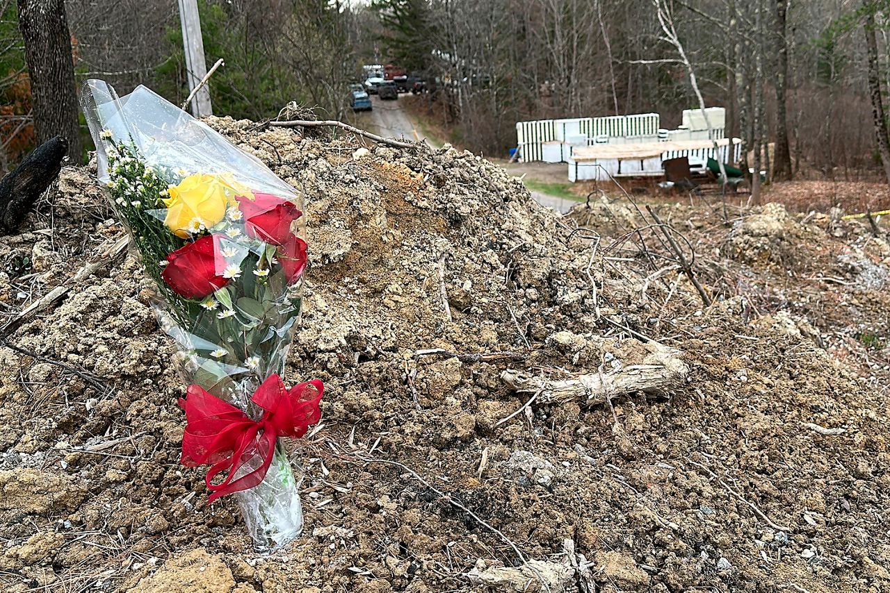 A lone bouquet of flowers marks a desolate makeshift memorial at the end of a driveway at a Bowdoin home, Wednesday, April 19, where police say four people were killed. A Maine man who police say killed four people in a home and then shot three others randomly on a busy highway had been released days earlier from prison, a state official said Wednesday. (AP Photo/Rodrique Ngowi)