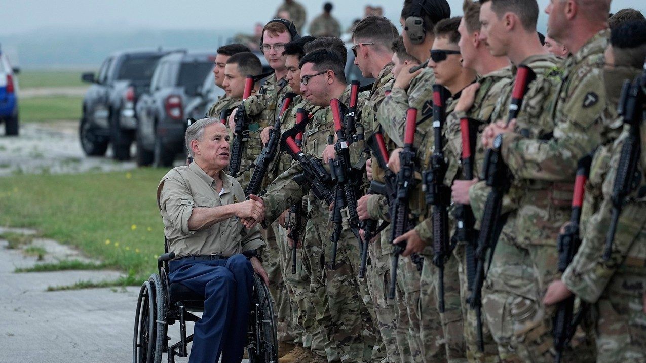 Texas Gov. Greg Abbott, left, shakes hands with members of the Texas National Guard as they prepare to deploy to the Texas-Mexico border in Austin, Texas, Monday, May 8, 2023. (AP Photo/Eric Gay)