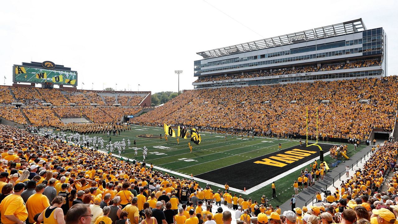 Fans cheer before an NCAA college football game between Iowa and North Texas at Kinnick Stadium in Iowa City, Iowa, Sept. 16, 2017. The University of Iowa announced 26 of its athletes across five sports are alleged to have participated in sports wagering in violation of NCAA rules. (AP Photo/Charlie Neibergall)