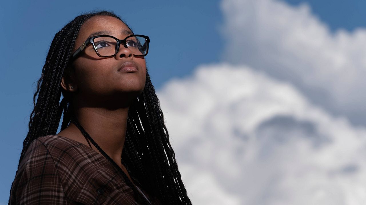 Harmony Kennedy, 16, a high school student, poses for a portrait in Nolensville, Tenn., on Tuesday, May 16, 2023. When the Tennessee legislature began passing legislation that could limit the discussion and teaching of Black history, gender identity and race in the classroom, to Harmony, it felt like a gut punch. "When I heard they were removing African American history, banning LGBTQ, I almost started crying," she says. (AP Photo/George Walker IV)