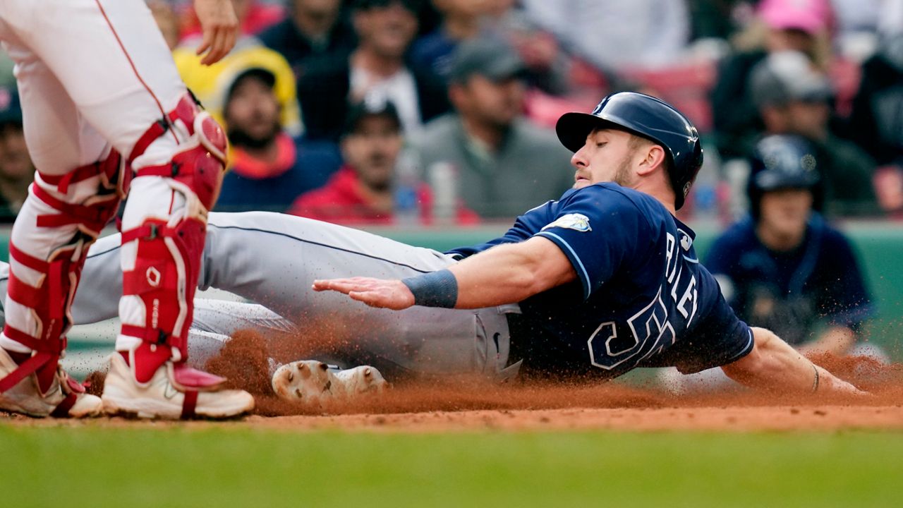 Tampa Bay Rays' Luke Raley slides safely to score on a single by Manuel Margot during the fifth inning of Monday's game against the Boston Red Sox.