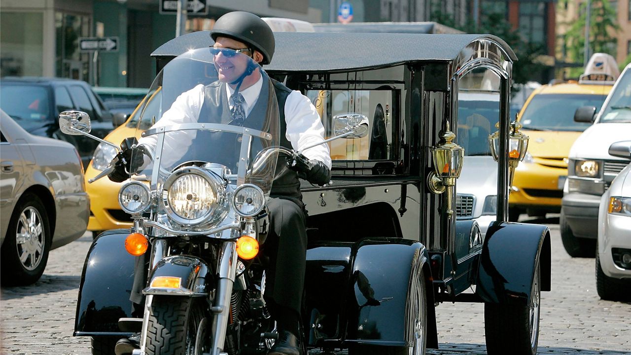  Peter Moloney, of Moloney Family Funeral Homes in Lake Ronkonkoma, N.Y., rides his Harley Davidson hearse from the Tombstone Hearse Co. of Alum Bank, Pa., in New York, May 24, 2007. Maloney was arrested Wednesday, June 7, 2023, on charges that he sprayed wasp killer at police officers and assaulted journalists — including an Associated Press photographer — during the Jan. 6, 2021, riot at the U.S. Capitol, authorities said. (AP Photo/Richard Drew)