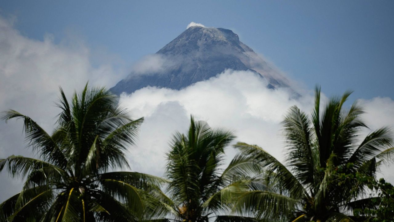 Mayon Volcano is seen from Guinobatan, Albay province, northeastern Philippines, Monday, June 12, 2023. The Philippines' most active volcano was gently spewing lava down its slopes Monday, alerting tens of thousands of people they may have to quickly flee a violent and life-threatening explosion. (AP Photo/Aaron Favila)