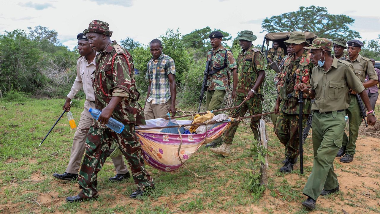 Police and local residents load the exhumed bodies of victims of a religious cult into the back of a truck in the village of Shakahola, near the coastal city of Malindi, in southern Kenya on April 23, 2023. The number of people who died after a Kenyan pastor ordered his followers to starve to death in order to meet Jesus is at more than 300, authorities said Tuesday June 13, 2023, and the death toll is expected to rise as more exhumations are planned. (AP Photo)