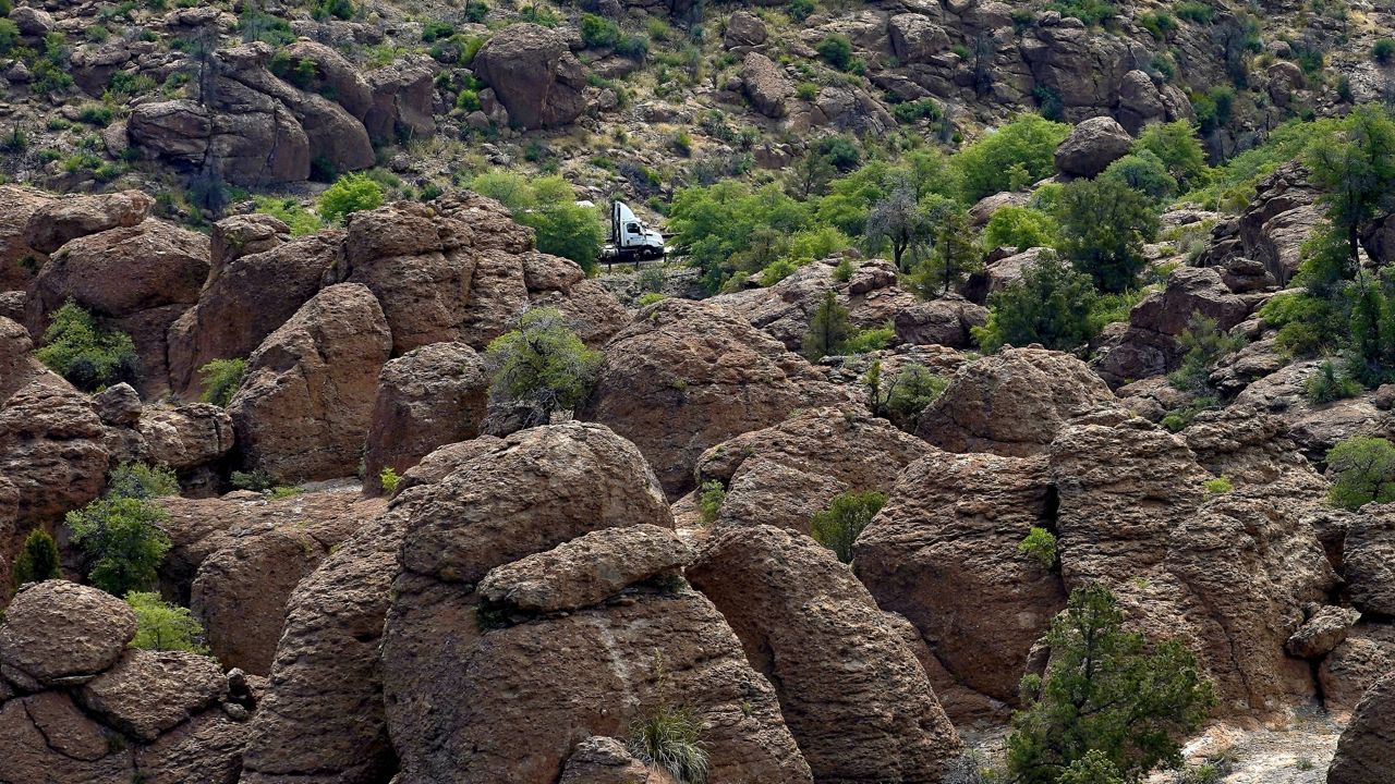 A tractor-trailer carrying supplies to the Resolution Copper Mining Company approaches the mine's main entrance, Friday, June 9, 2023, in Miami, Ariz. (AP Photo/Matt York)