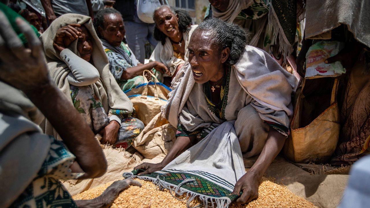 An Ethiopian woman argues with others over the allocation of yellow split peas after it was distributed by the Relief Society of Tigray in the town of Agula, in the Tigray region of northern Ethiopia, on May 8, 2021. (AP Photo/Ben Curtis)