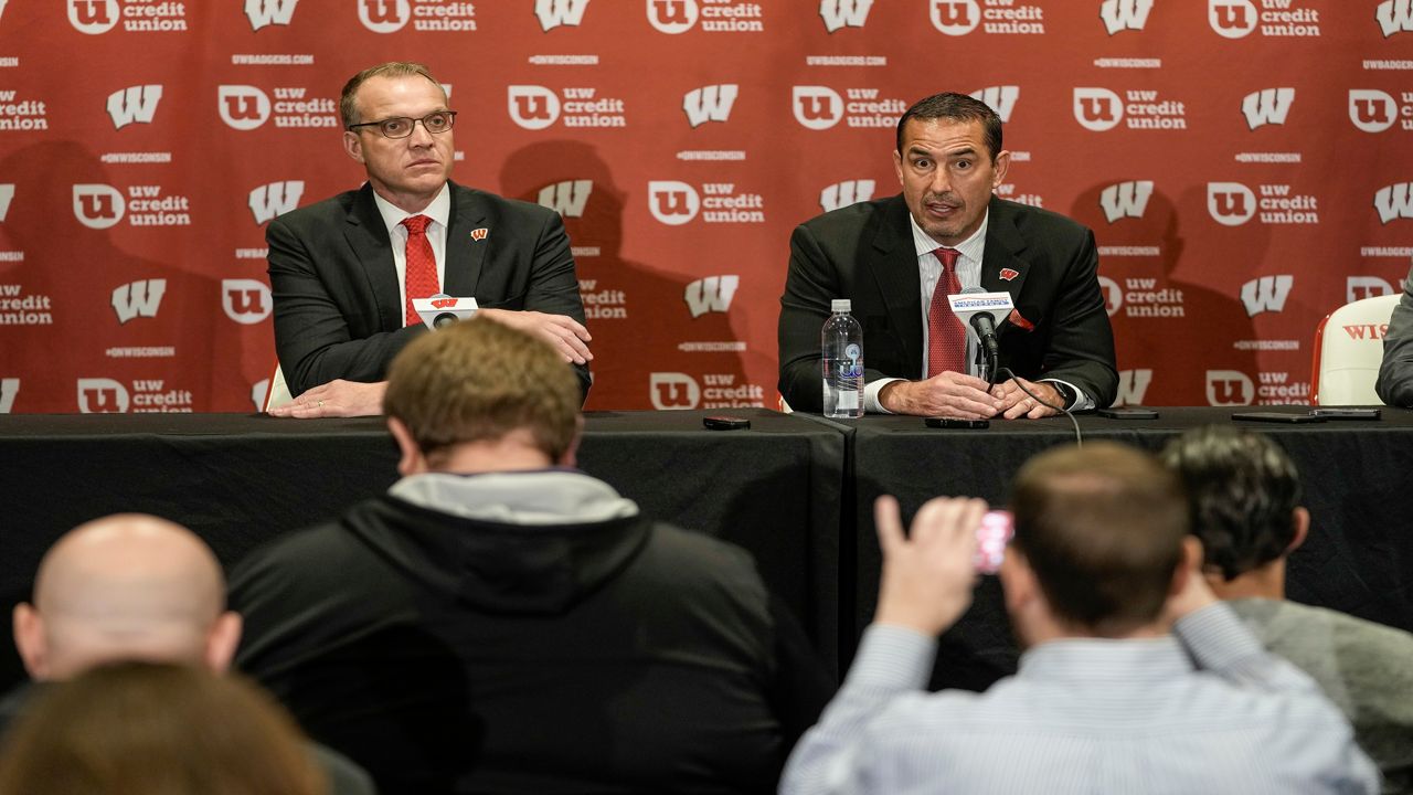 FILE - Wisconsin athletic director Chris McIntosh, left, introduces new head football coach Luke Fickell at a news conference Monday, Nov. 28, 2022, in Madison, Wis. McIntosh’s emergence as Wisconsin’s athletic director after playing football for the Badgers and working as predecessor Barry Alvarez’s right-hand man seemed to indicate things would stay essentially the same at a school that prides itself on stability. It hasn’t worked out that way. (AP Photo/Morry Gash, File)