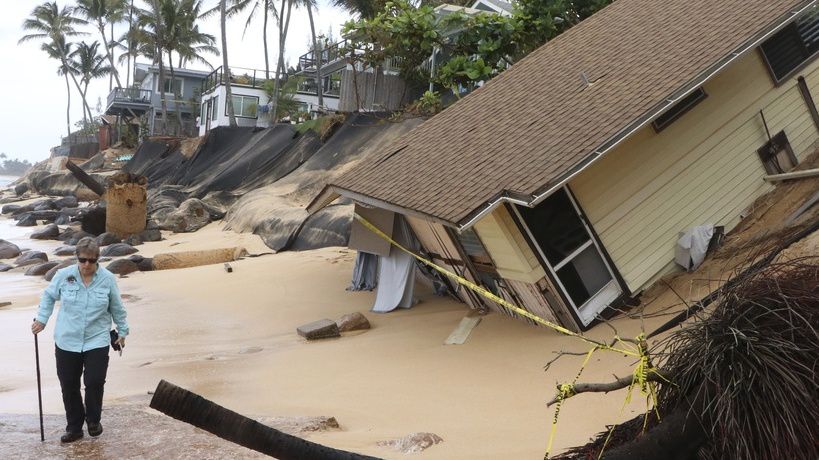 This photo provided by the Hawaii Department of Land and Natural Resources, shows a home after it collapsed onto a beach on Feb. 28, 2022, in Haleiwa, Hawaii. Rising seas and more intense storms are encroaching on coastal properties. Some coastal erosion removes sand surrounding cesspools and pulls sewage out to sea. (Dan Dennison/Hawaii Department of Land and Natural Resources via AP)