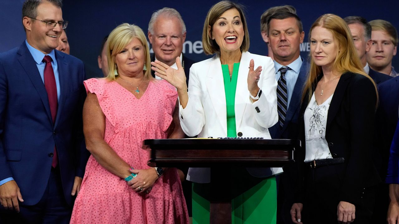  Iowa Gov. Kim Reynolds reacts after signing a new law banning abortions after six weeks of pregnancy before speaking at the Family Leadership Summit, Friday, July 14, 2023, in Des Moines, Iowa. (AP Photo/Charlie Neibergall)
