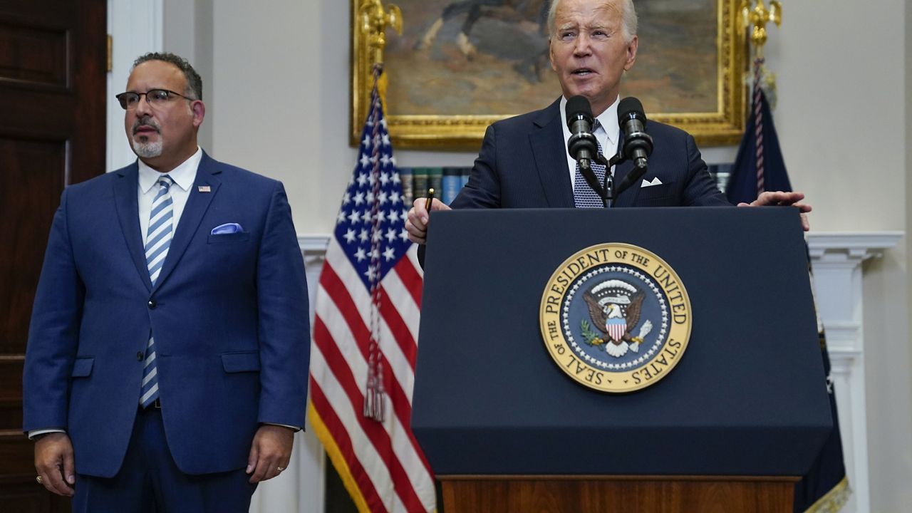 President Joe Biden speaks in the Roosevelt Room of the White House, June 30, 2023, in Washington, as his administration is moving forward on a new student debt relief plan after the Supreme Court struck down his original initiative. Education Secretary Miguel Cardona listens at left. Two conservative groups are asking a federal court to block the Biden administration’s plan to cancel $39 billion in student loans for more than 800,000 borrowers. (AP Photo/Evan Vucci, File)