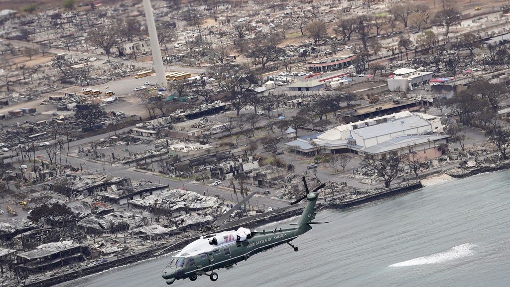 President Joe Biden and first lady Jill Biden take an aerial tour on Marine One over areas devastated by the Maui wildfires, Aug. 21, 2023, in Lahaina, Hawaii. (AP Photo/Evan Vucci)