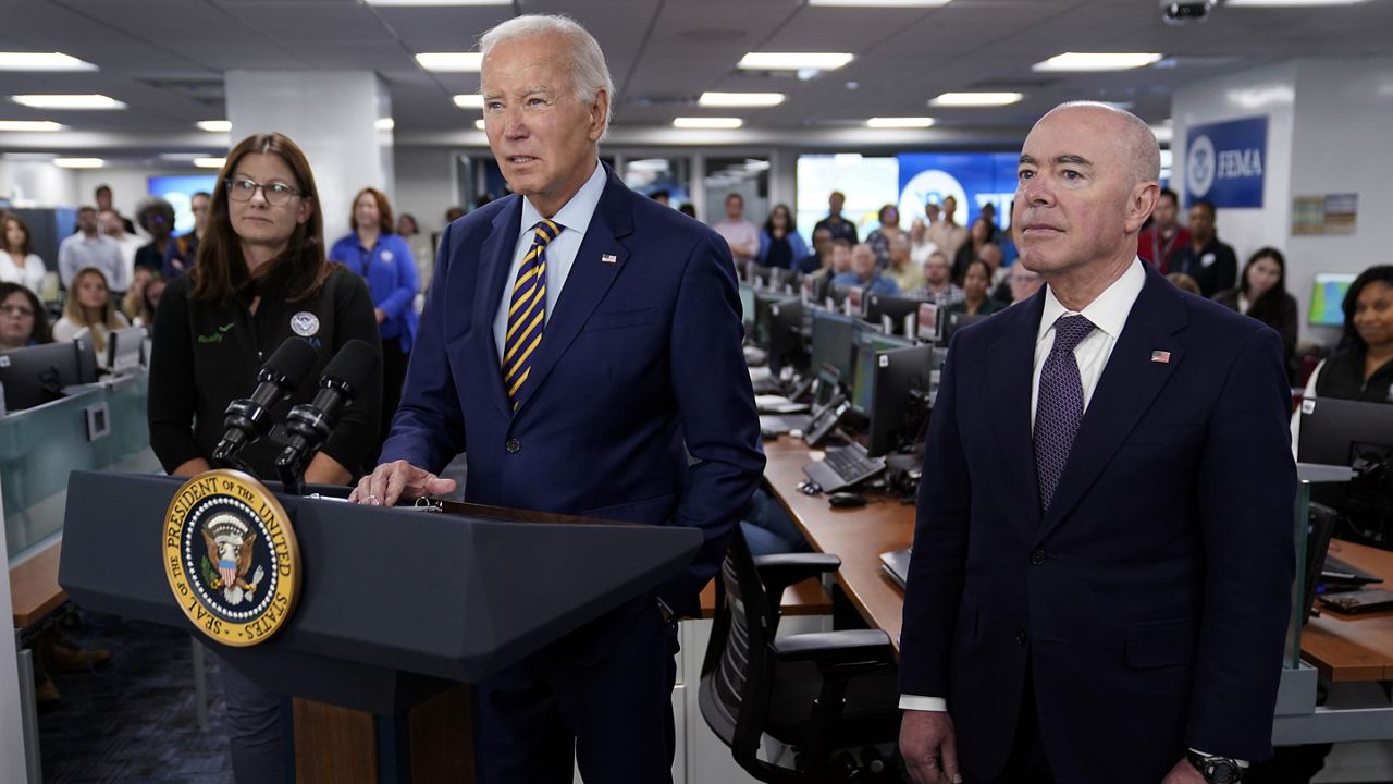 President Joe Biden speaks during a visit to FEMA headquarters, Thursday, Aug. 31, 2023, in Washington. Homeland Security Secretary Alejandro Mayorkas, right, and FEMA Associate Administrator of the Office of Response and Recovery Anne Bink, left, listen. (AP Photo/Evan Vucci)