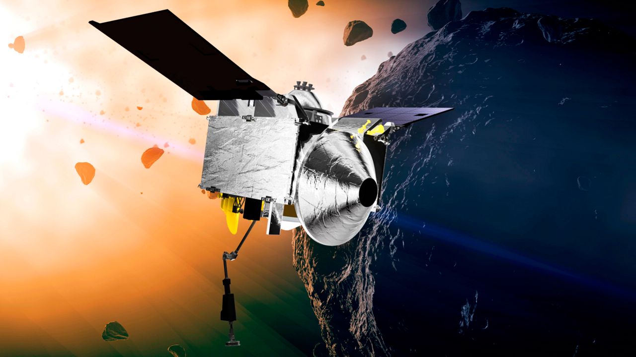 This illustration provided by NASA depicts the OSIRIS-REx spacecraft at the asteroid Bennu. On Sunday, Sept. 24, 2023, the spacecraft will flew by Earth and dropped off what is expected to be at least a cupful of rubble it grabbed from the asteroid Bennu, closing out a seven-year quest. (Conceptual Image Lab/Goddard Space Flight Center/NASA via AP, File)
