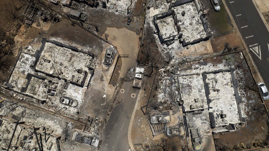 Charred cars and buildings are visible in the aftermath of a wildfire in Lahaina, Hawaii, Aug. 22, 2023. Federal authorities have started removing hazardous materials from the Maui wildfires and laying the groundwork to dispose of burnt cars, buildings and other debris. The hazardous materials, including oil, solvent and batteries, are being shipped to the West Coast while the U.S. Army Corps of Engineers works with local officials to develop a plan to dispose of an estimated 400,000 to 700,000 tons of debris on the island. (AP Photo/Jae C. Hong, File)